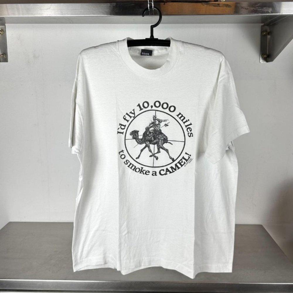 80S ID Fly 10,000 Miles To Smoke A Camel War Humor Single Stitch Shirt - Picture 1 of 4